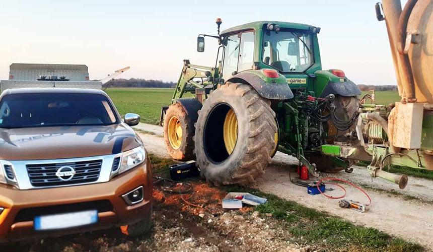 Eilige Pannenhilfe bei einem havarierten Hinterreifen eines Traktors