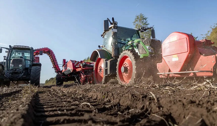Traktor mit schmalen Reifen für einen gezogenen Kartoffelroder